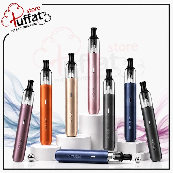 Six Geekvape Wenax M2 devices in assorted colors (purple, orange, rose gold, black, blue, and dark gray) are displayed on white pedestals, with one blue device lying horizontally in the foreground. The image features a 'Puffat' store logo in the top-left corner.