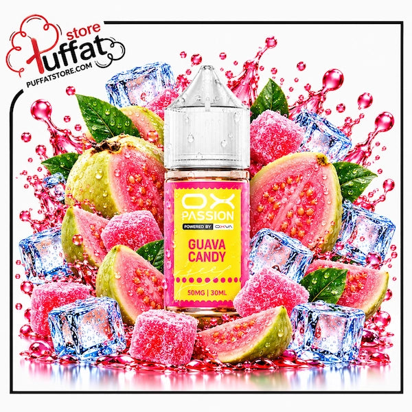 A 30ml bottle of OX PASSION Guava Candy freeze salt nicotine e-liquid (50mg) with a transparent droplet-covered dropper cap, centered among whole and sliced ripe pink guavas, sugar-dusted pink jelly candy cubes, green leaves, and crystal-clear ice cubes, framed by dynamic splashes of vibrant pink juice over a reflective surface on a white background, enclosed in a thin black border with the Puffat Store logo in the top-left corner.