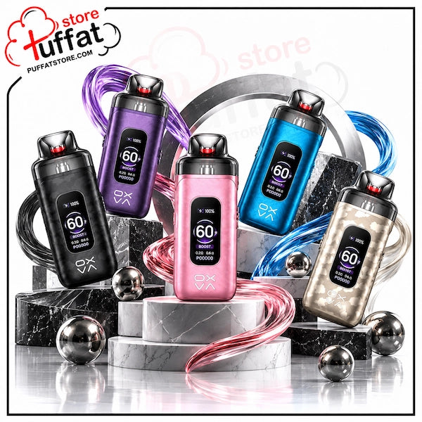 Four vape devices displayed on a white studio background with decorative marble blocks, metallic spheres, and flowing colored ribbons. The devices come in black, purple, blue, pink, and champagne gold finishes, each with a digital display showing '60' and the brand logo 'OX'.