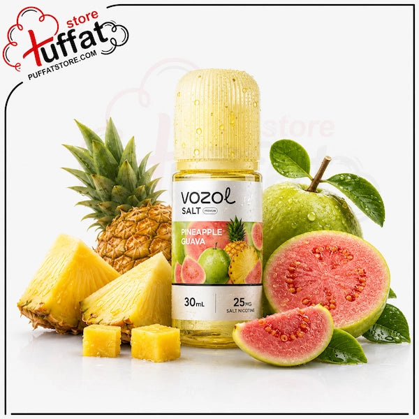 A bottle of Vozol Salt Pineapple Guava e-liquid centered on a white background, surrounded by fresh pineapple slices, whole pineapple, green apples, and pink guava fruit. The Vozol Salt brand label is visible on the bottle, and a Tuffat store watermark appears in the top left corner.
