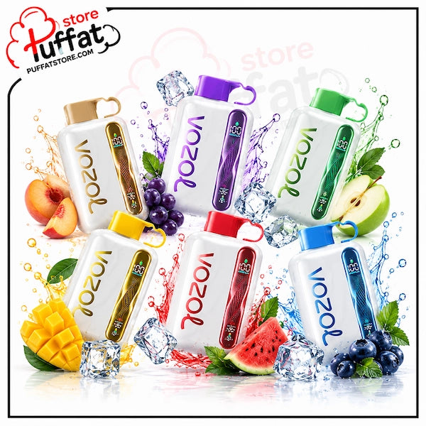 Six Vozol disposable vape devices in assorted colors (gold, purple, green, yellow, red, blue) arranged in a dynamic cluster with water splashes, ice cubes, and fresh fruits like watermelon, mango, grapes, blueberries, and an apple on a white background. A 'Puffat store' watermark is visible in the top left corner.