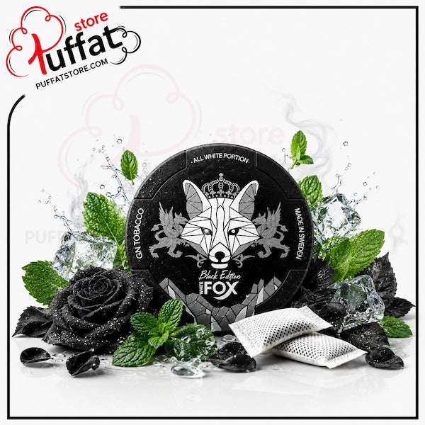 A round black iFOX Blue Edition gummy packaging label with a white fox graphic, surrounded by mint leaves, black rose petals, ice cubes, and two silver gummy packets on a white background. A 'Huffat' store watermark is visible in the top left corner.