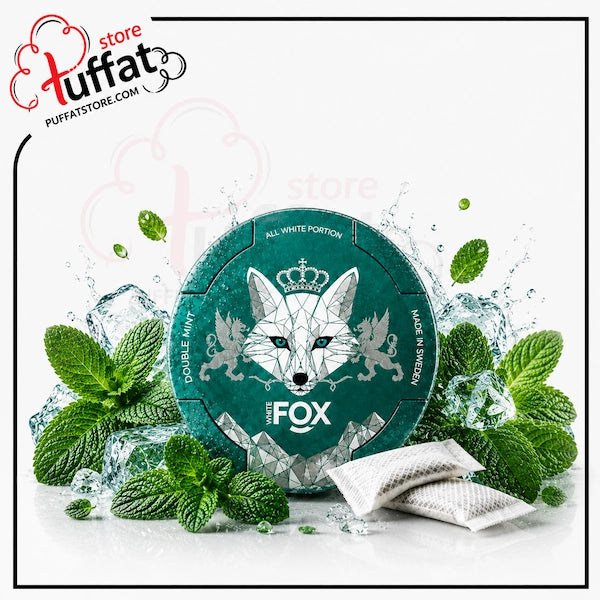 A round teal tin labeled 'The Fox' with a white fox illustration, surrounded by mint leaves, ice cubes, and two sachets on a white background. A 'tuffat store' watermark/logo appears in the top left.