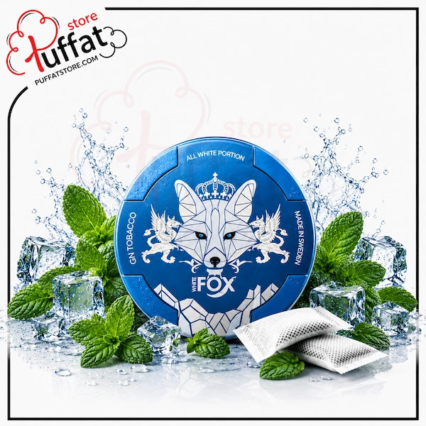 A round blue pack of Fox the Wolf gum against a white background, surrounded by ice cubes, mint leaves, and two silver foil packets. The pack features a white geometric wolf design with a crown and the text 'ALL WHITE PORTION' and 'MADE IN SWEDEN'.